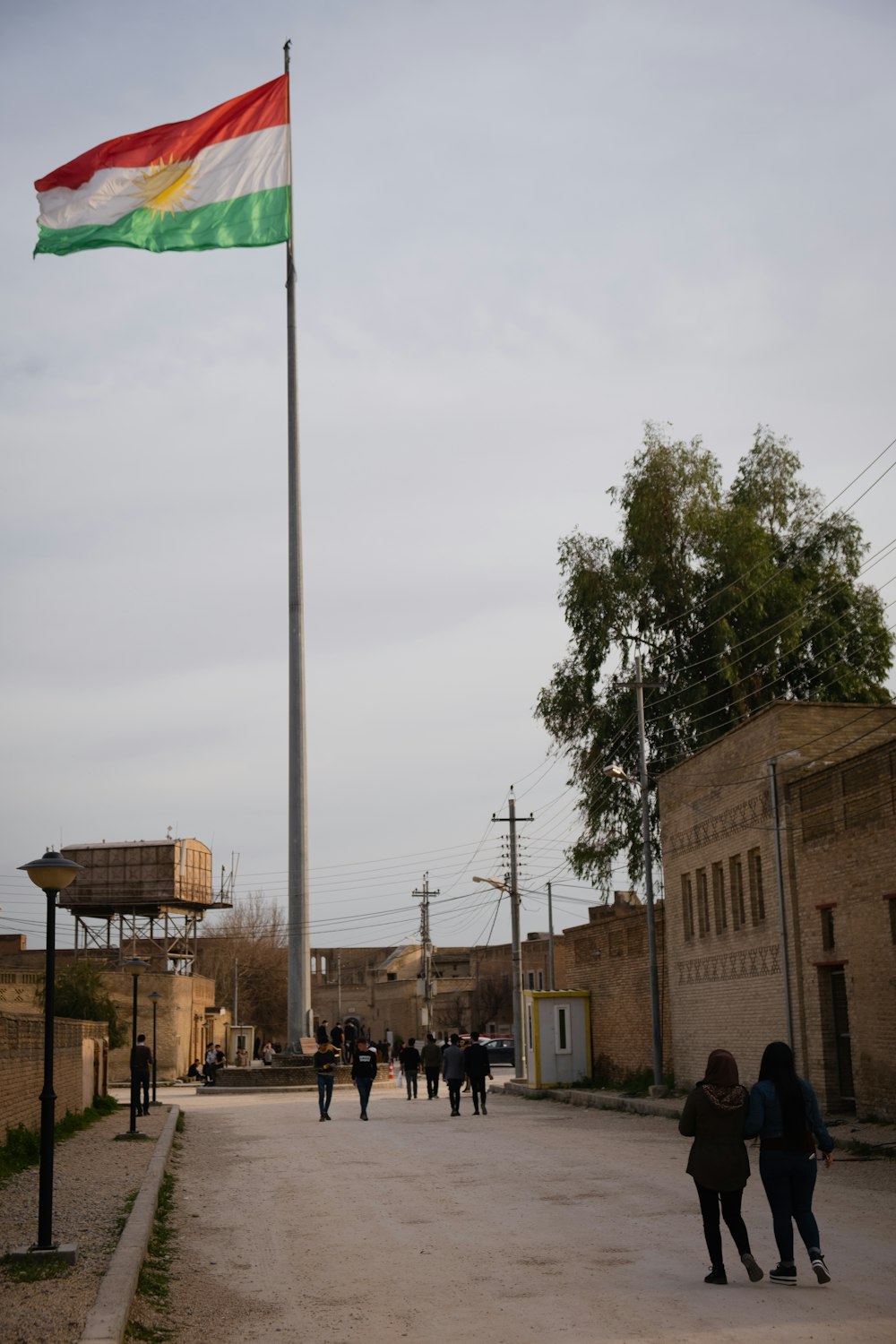 green flag on pole near building during daytime