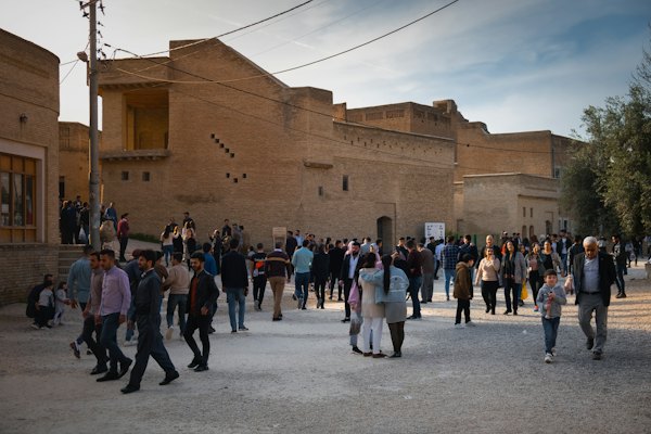 People standing in front of brown concrete building during daytime — Erbil, Iraq
