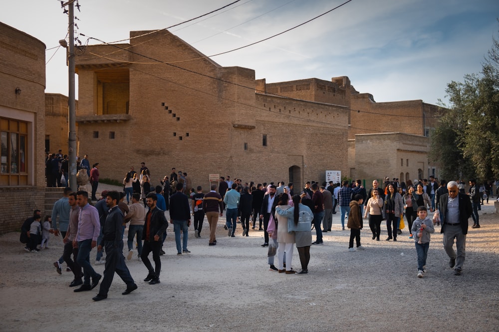 people standing in front of brown concrete building during daytime