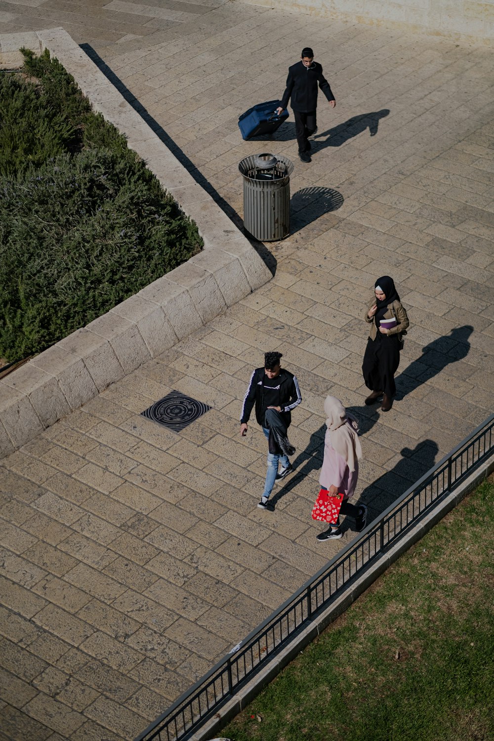 man in black t-shirt and blue denim jeans sitting on gray concrete bench