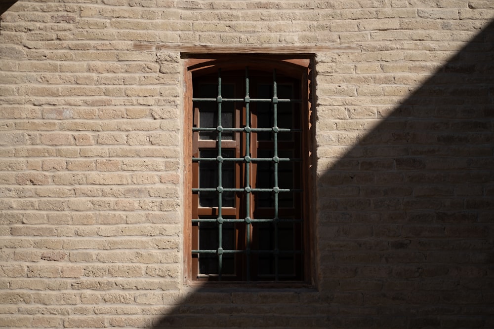 brown wooden window on brown brick wall