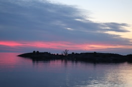 Sunset view over Isla Isabel’s marine park with silhouettes of birds flying above the calm sea.
