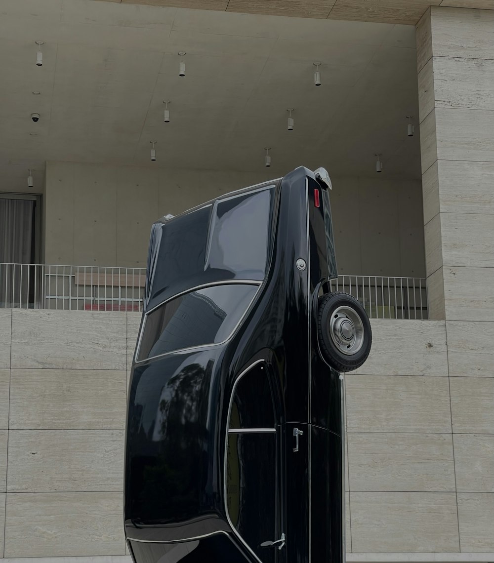 black car parked near white building