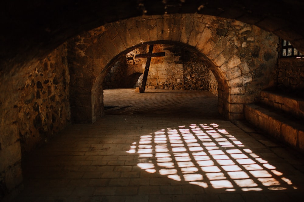 brown brick tunnel with black metal railings