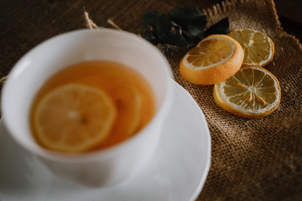 sliced orange fruit on white ceramic cup