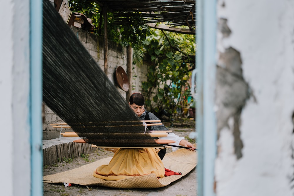 man in brown shirt sitting on hammock