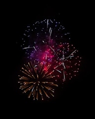 a colorful fireworks is lit up in the night sky