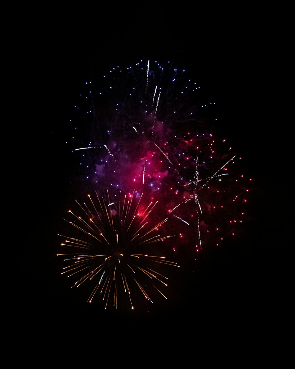 a colorful fireworks is lit up in the night sky