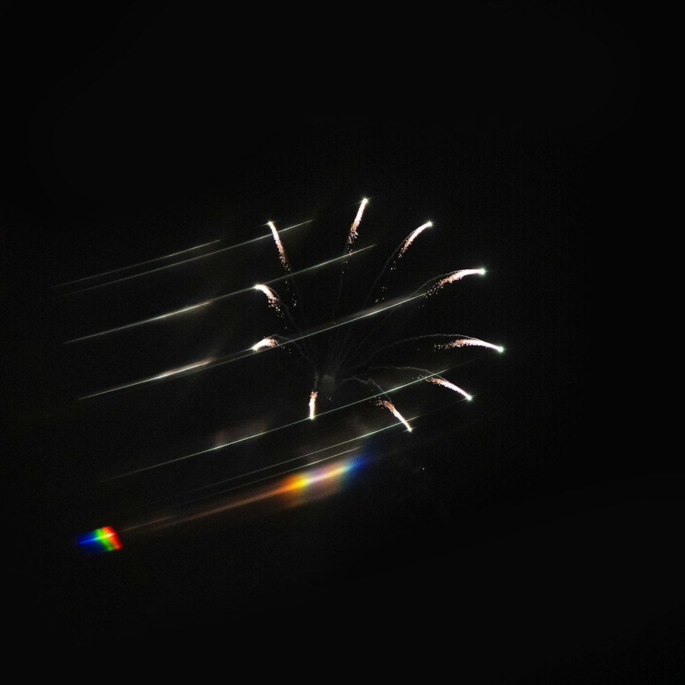 a group of fireworks are lit up in the night sky