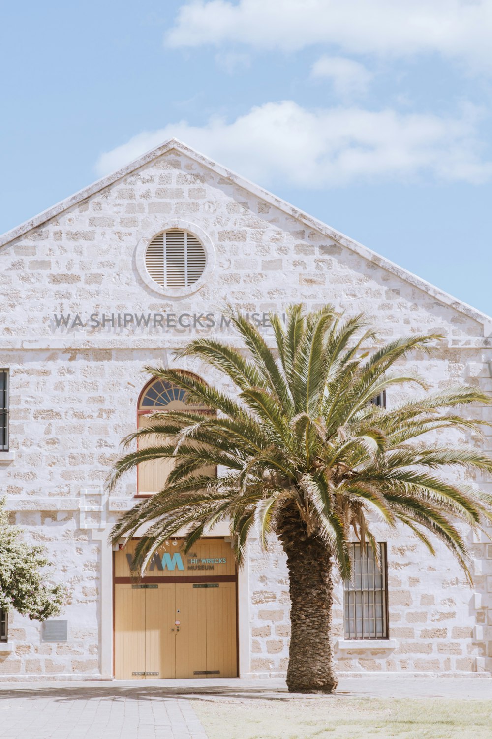 a building with a palm tree in front of it