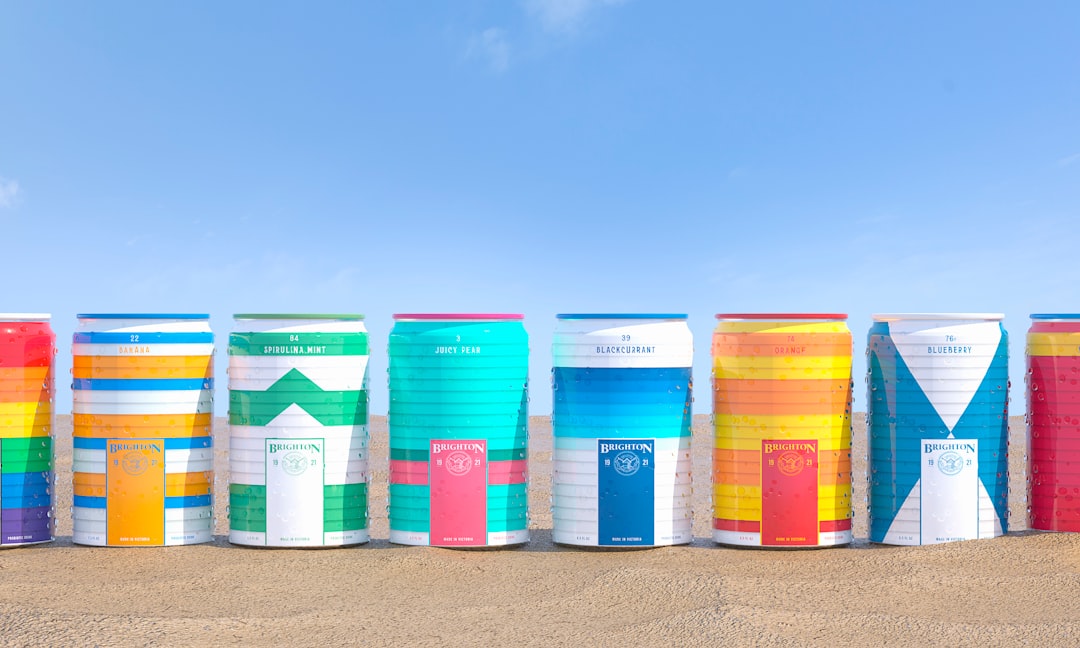 blue red and green plastic containers on gray sand during daytime