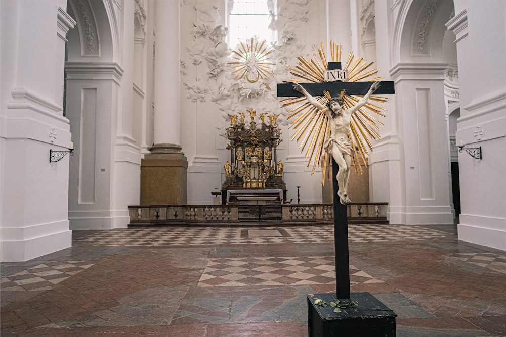 gold and black cross on white concrete building