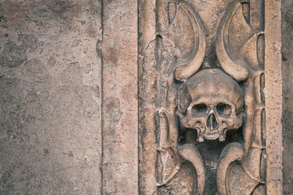 brown concrete wall with human face carved