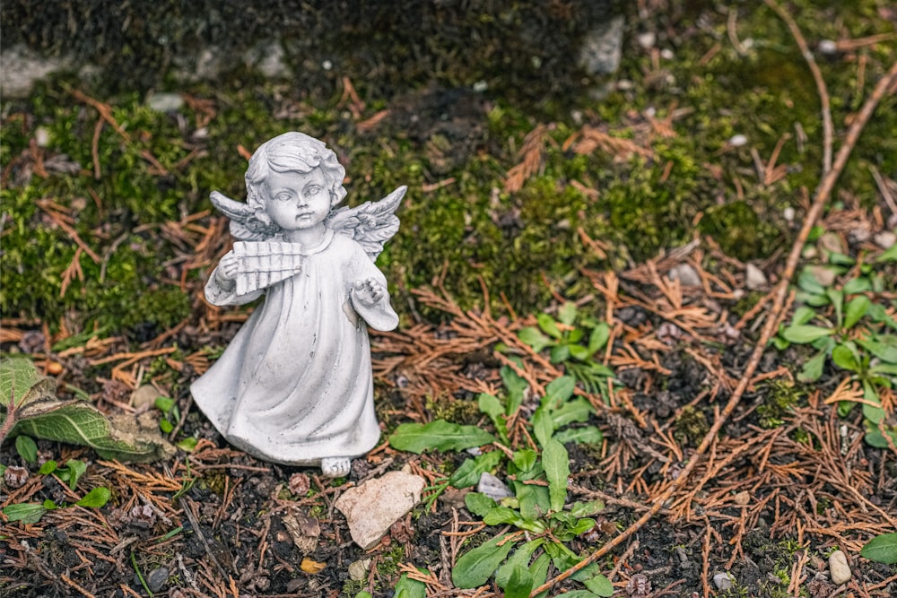 angel ceramic figurine on brown dried leaves