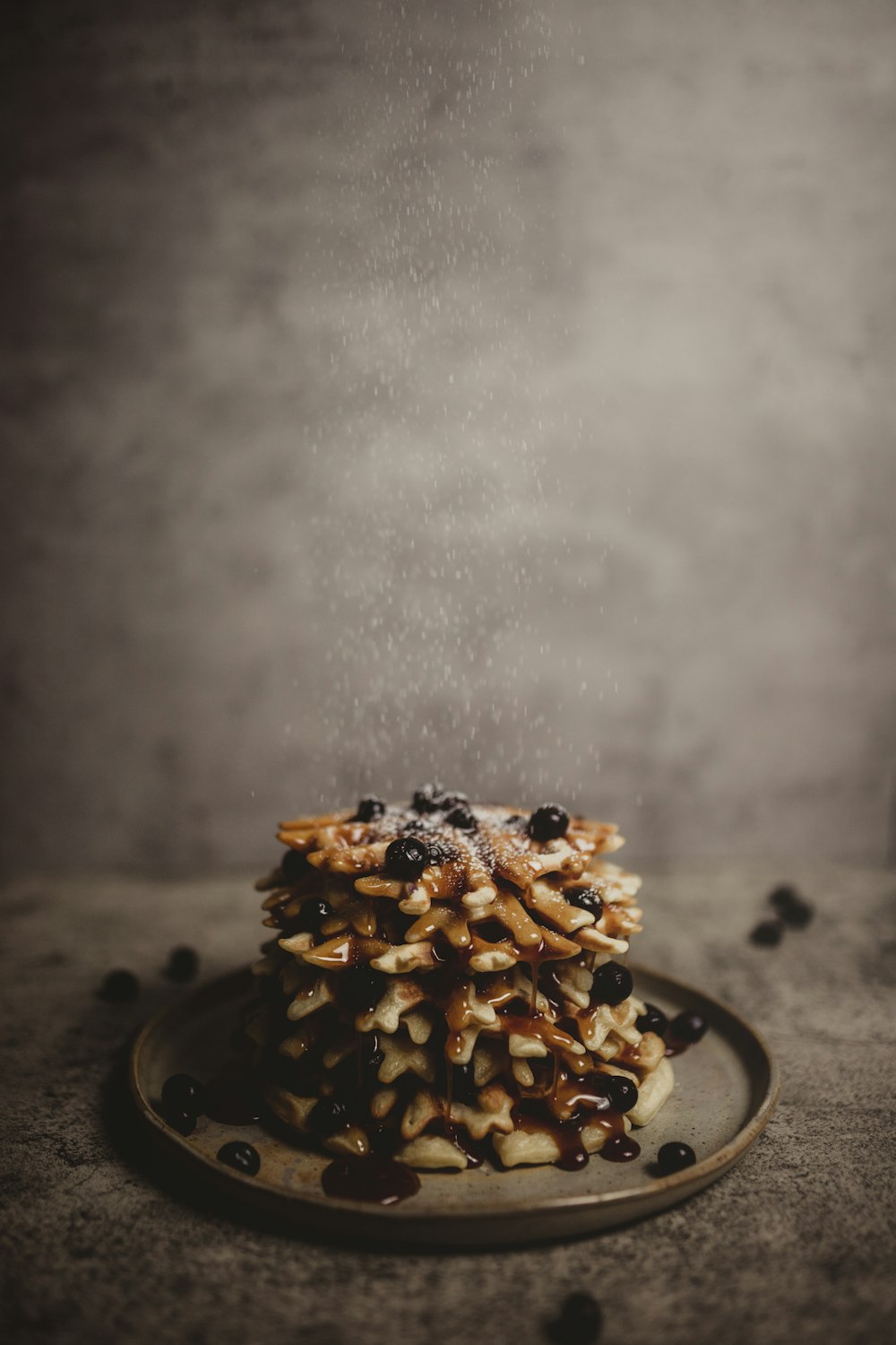 brown and black cake with white icing on top