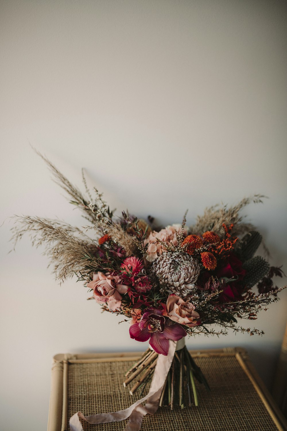 pink and white flowers on white ceramic vase