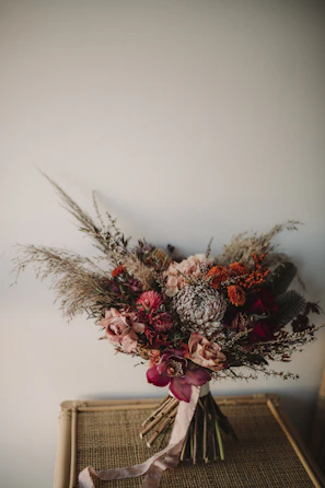 pink and white flowers on white ceramic vase