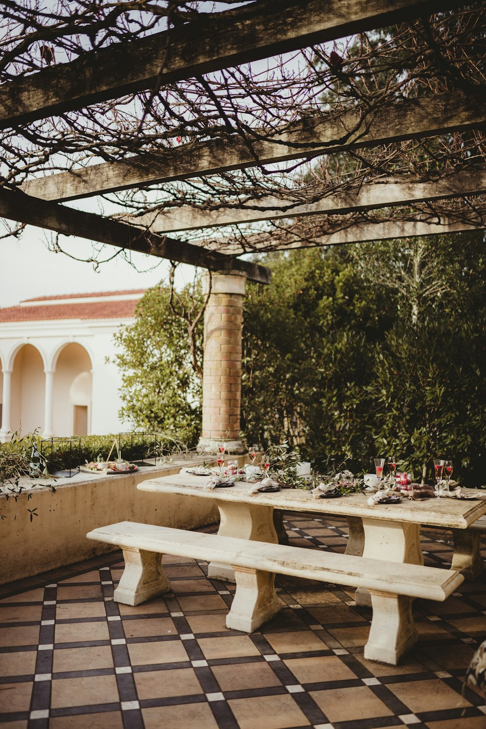 white wooden table and chairs near trees during daytime