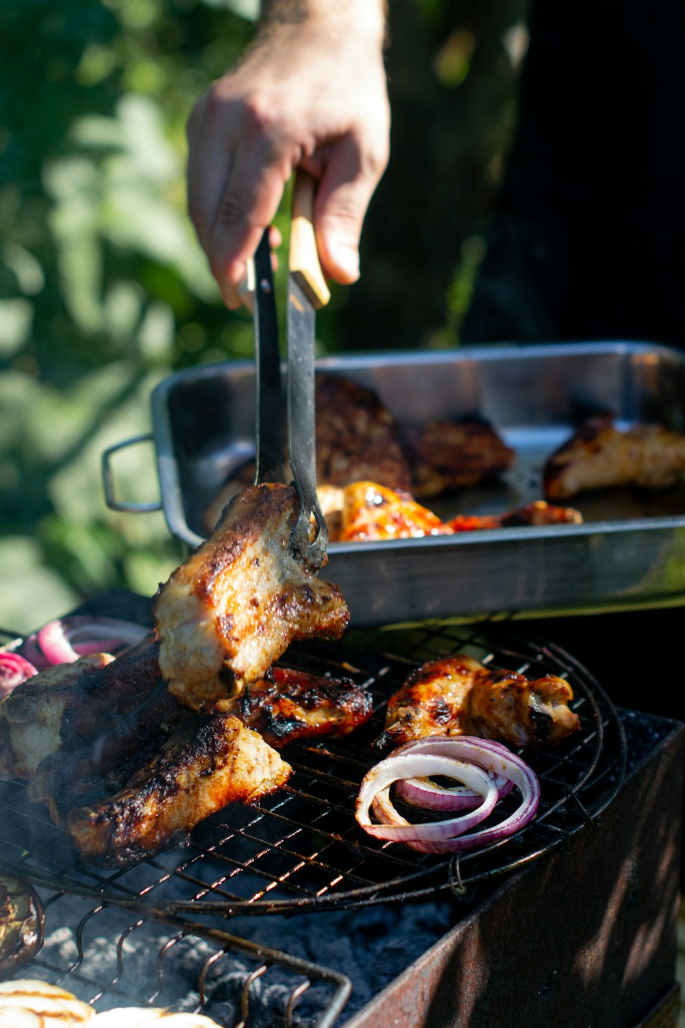 person holding stainless steel fork and steak knife slicing meat