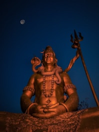 gold buddha statue under blue sky during nighttime