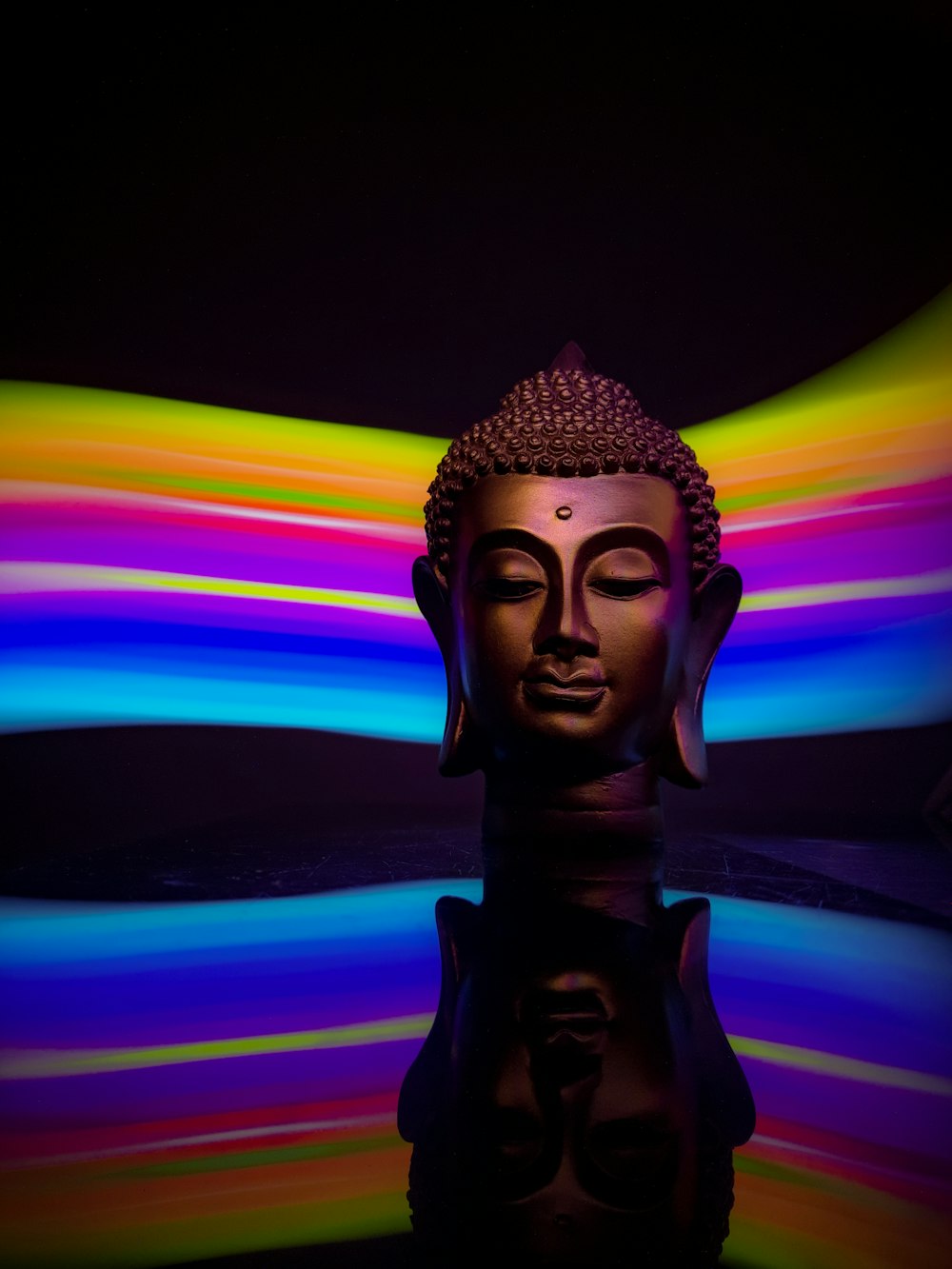gold buddha statue with rainbow background