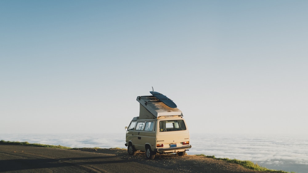 white van on beach during daytime