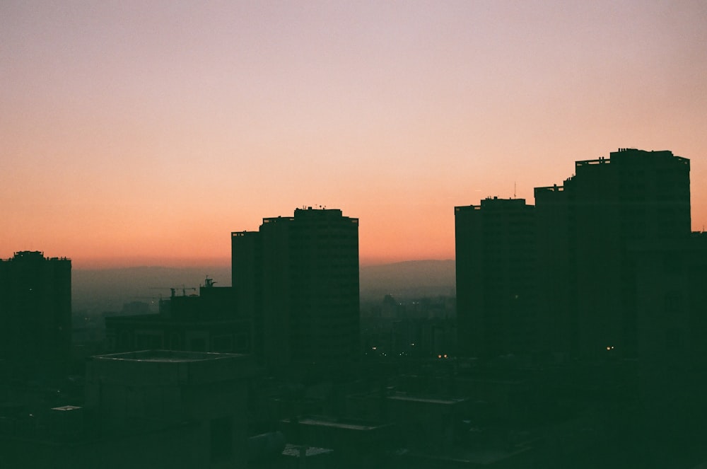 silhouette of city buildings during sunset