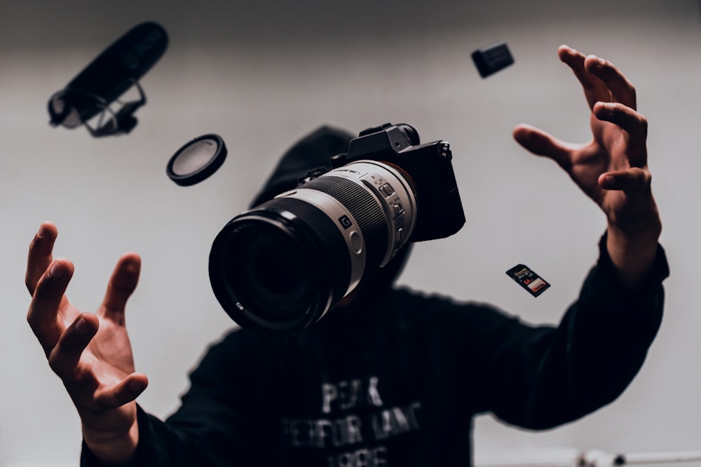 person holding black nikon dslr camera