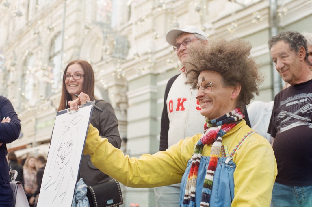 woman in yellow jacket holding white printer paper