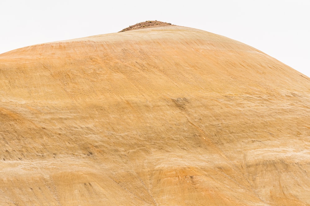 brown rock formation under white sky during daytime