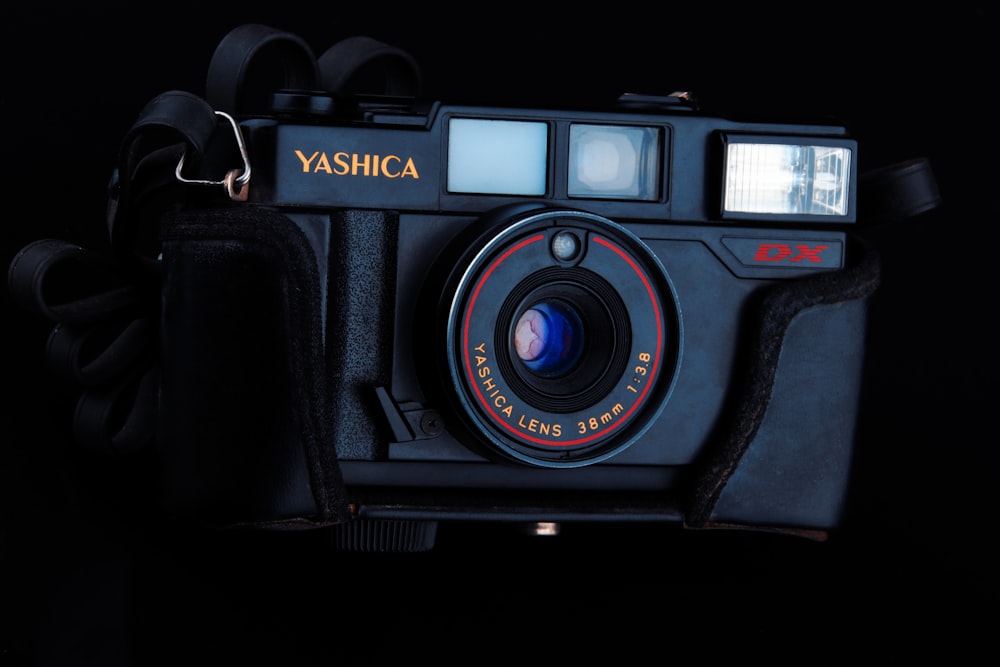 Schwarze Nikon DSLR-Kamera auf schwarzer Oberfläche