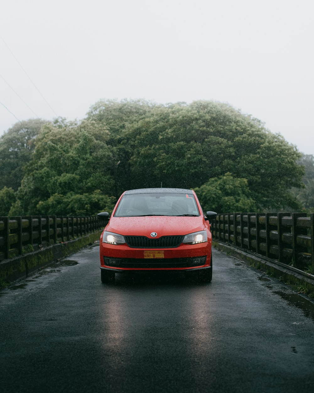 red car on black asphalt road during daytime