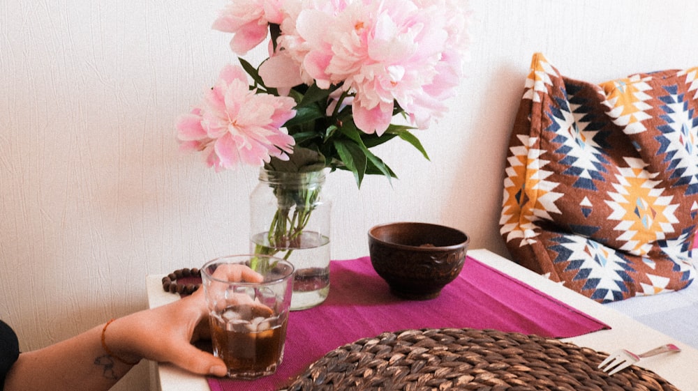 pink and white flower on clear glass vase