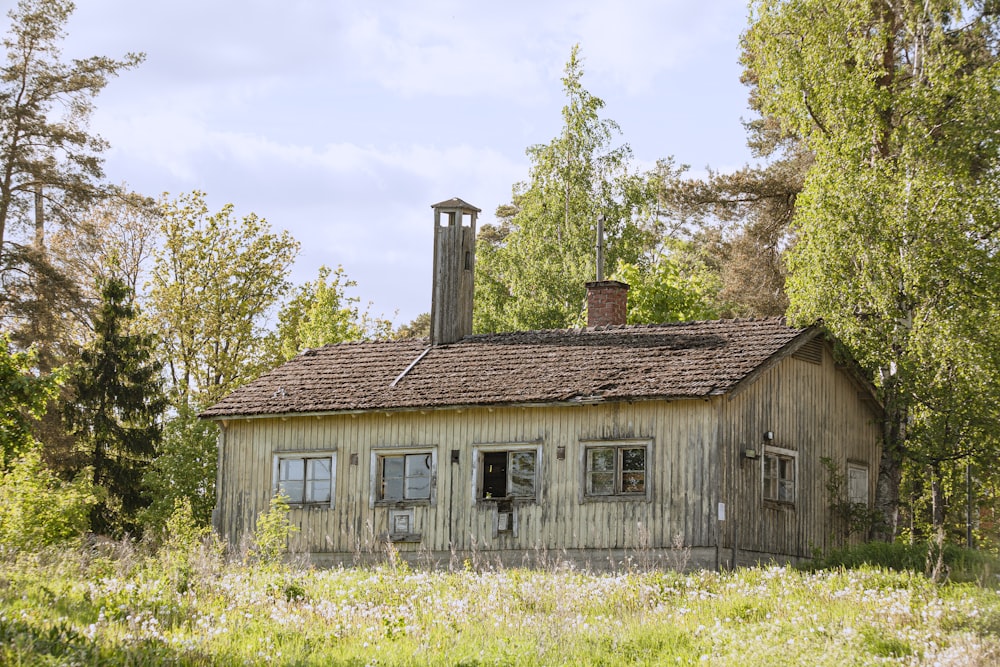 brown wooden house near green trees during daytime