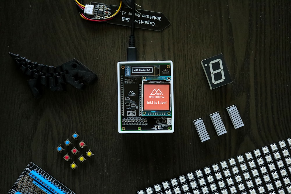 electronic components laid out on a wooden table