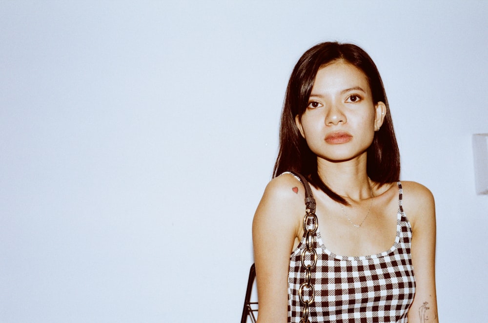 woman in black and white checkered sleeveless top