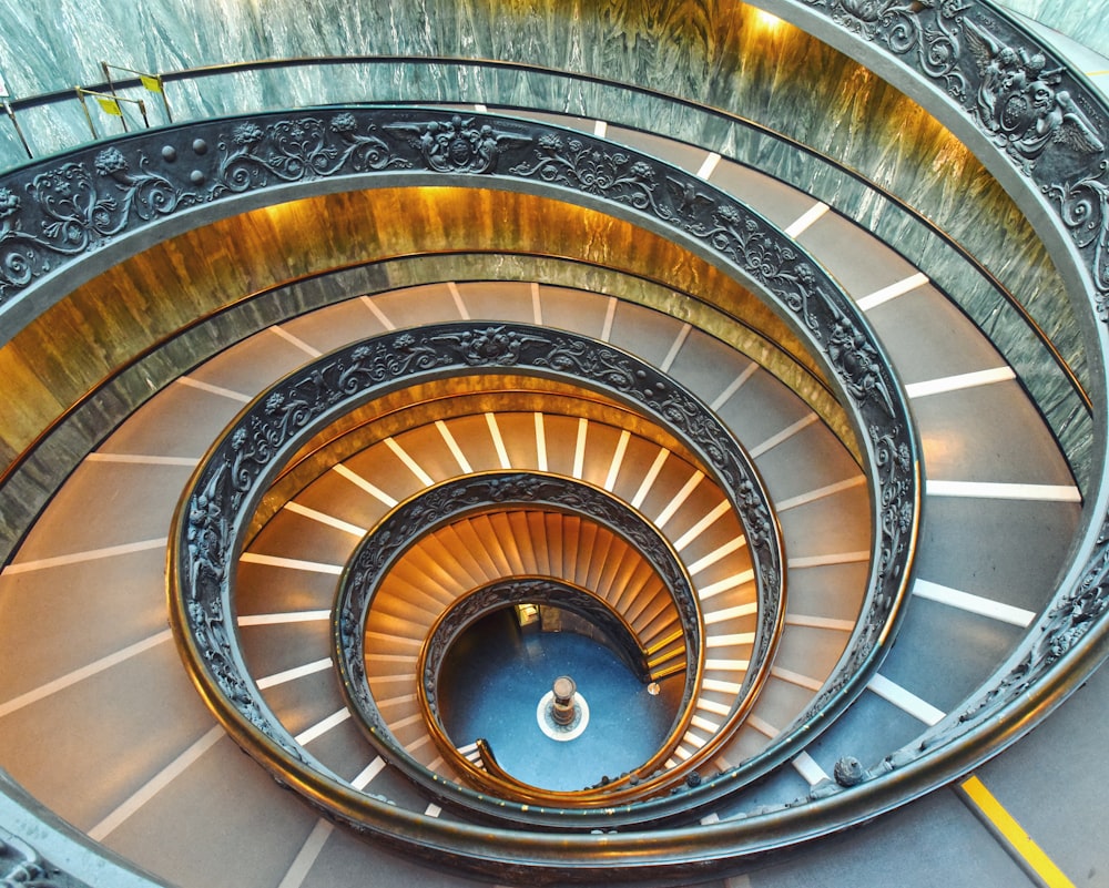 brown spiral staircase with white wooden railings