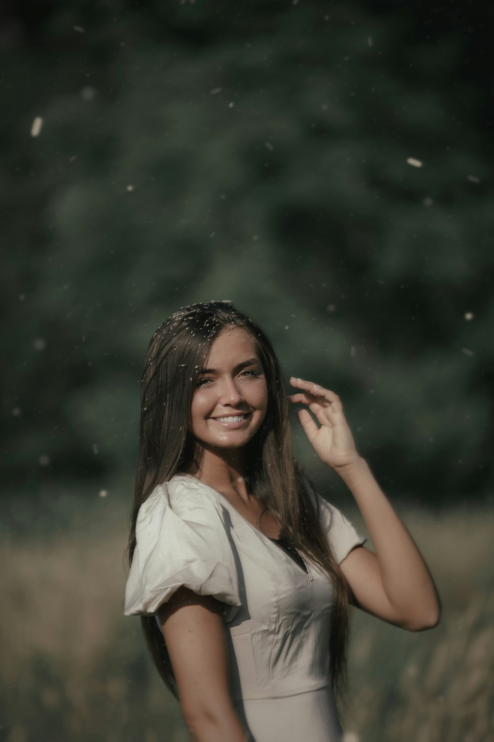 woman in white shirt holding her hair