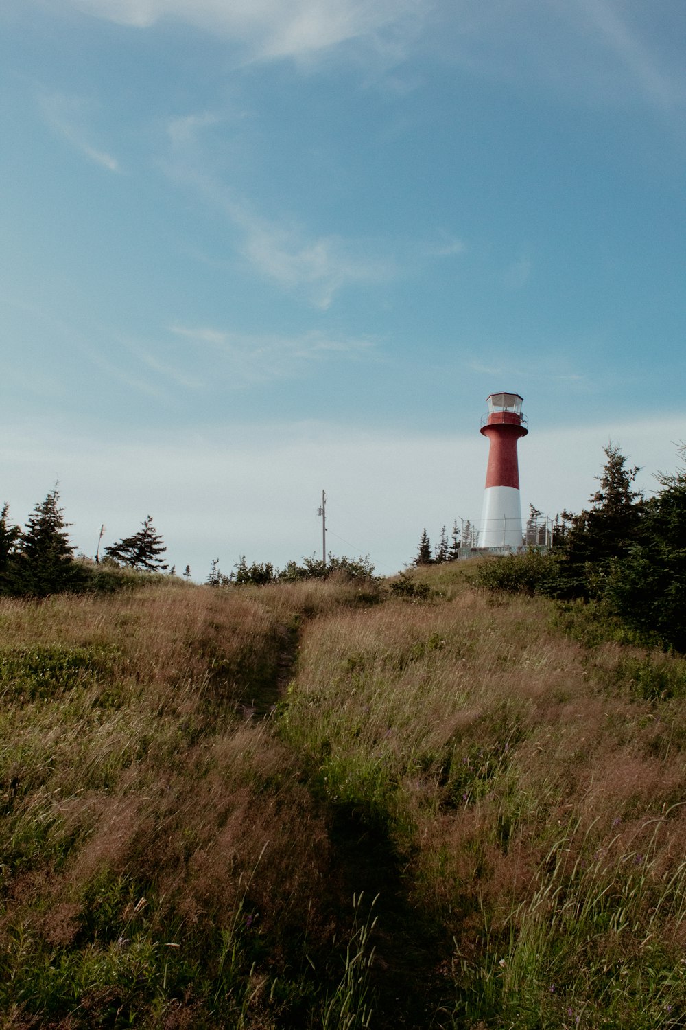 white and red lighthouse under blue sky during daytime