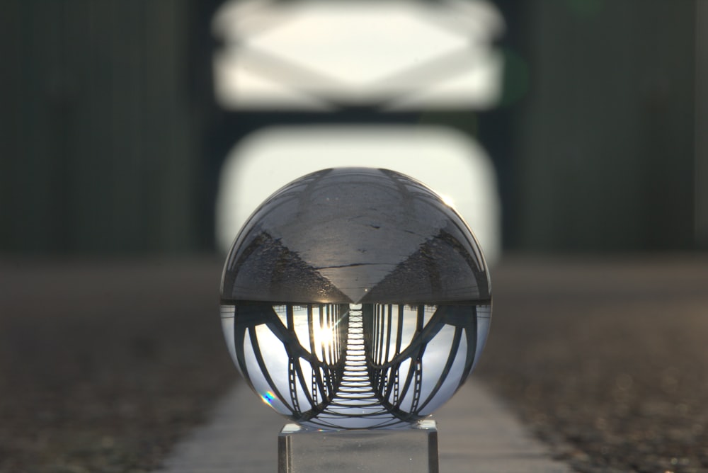 clear glass ball on brown sand