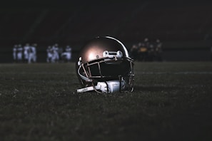Close-up of a Broncos helmet resting on the turf before kickoff