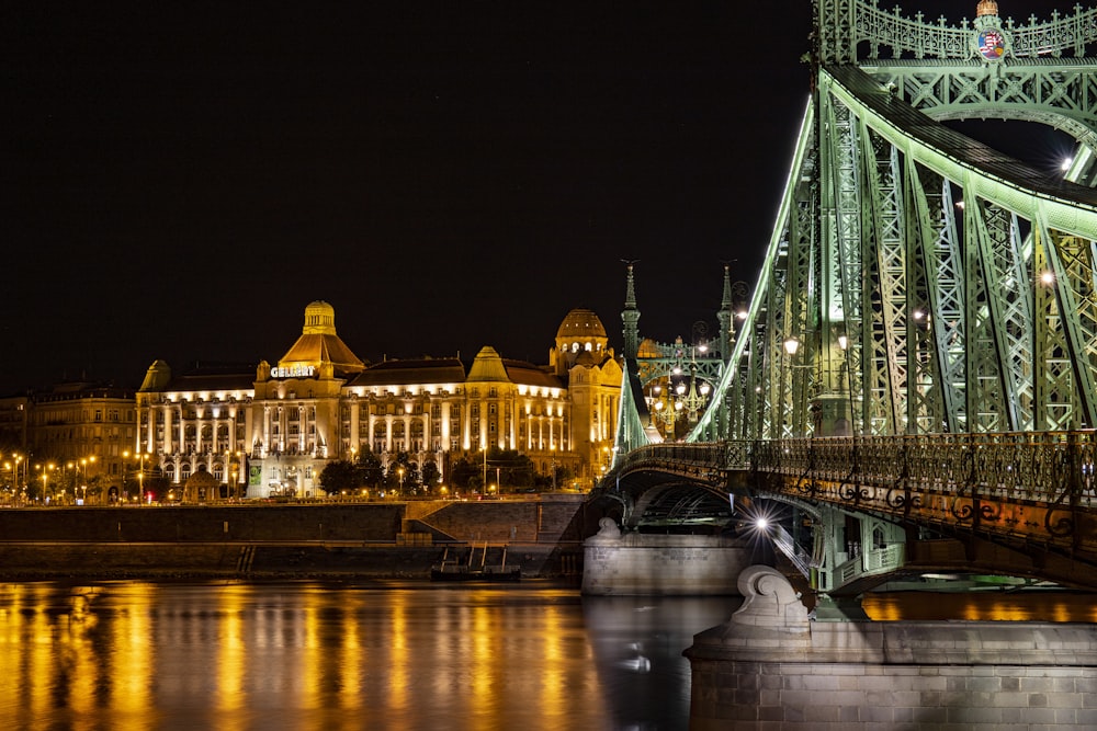 green bridge with lights during night time