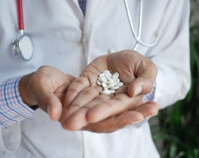 person holding white flower petals