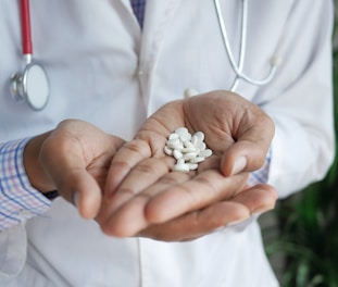 person holding white flower petals