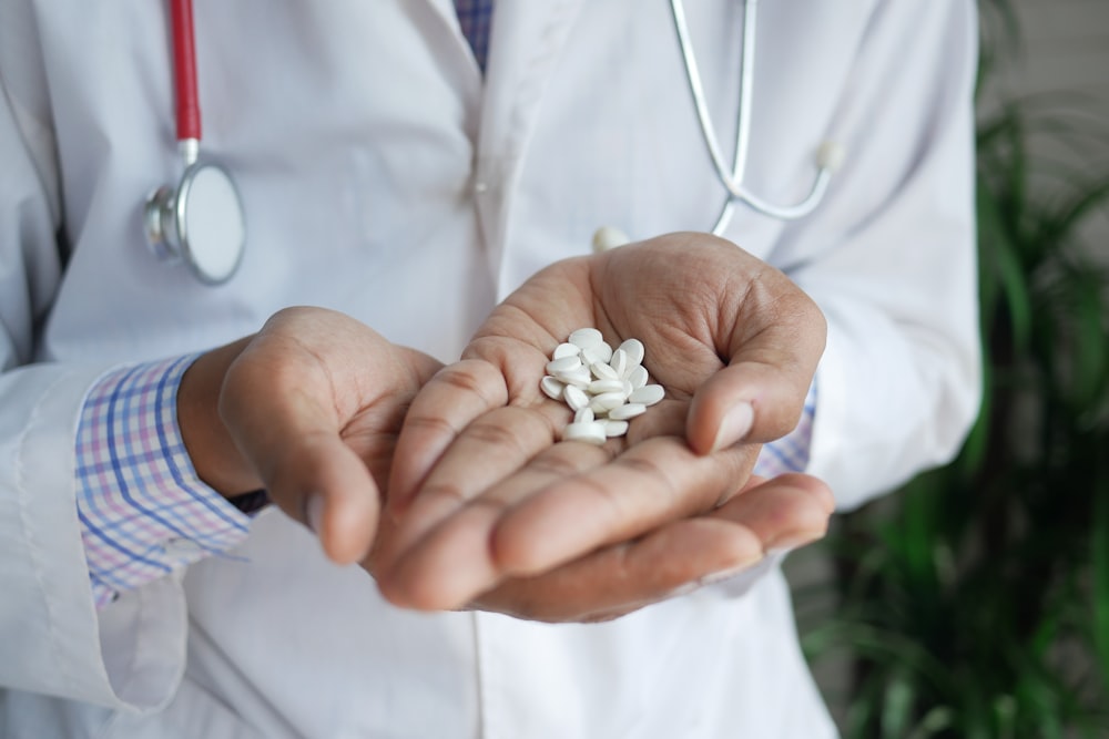 person holding white flower petals