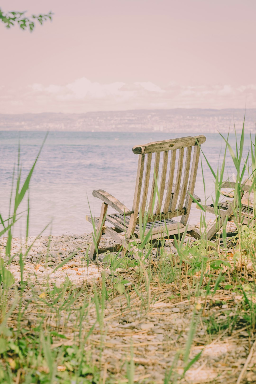 brown wooden armchair on seashore during daytime