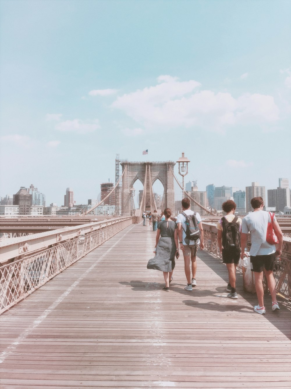 people walking on wooden bridge during daytime