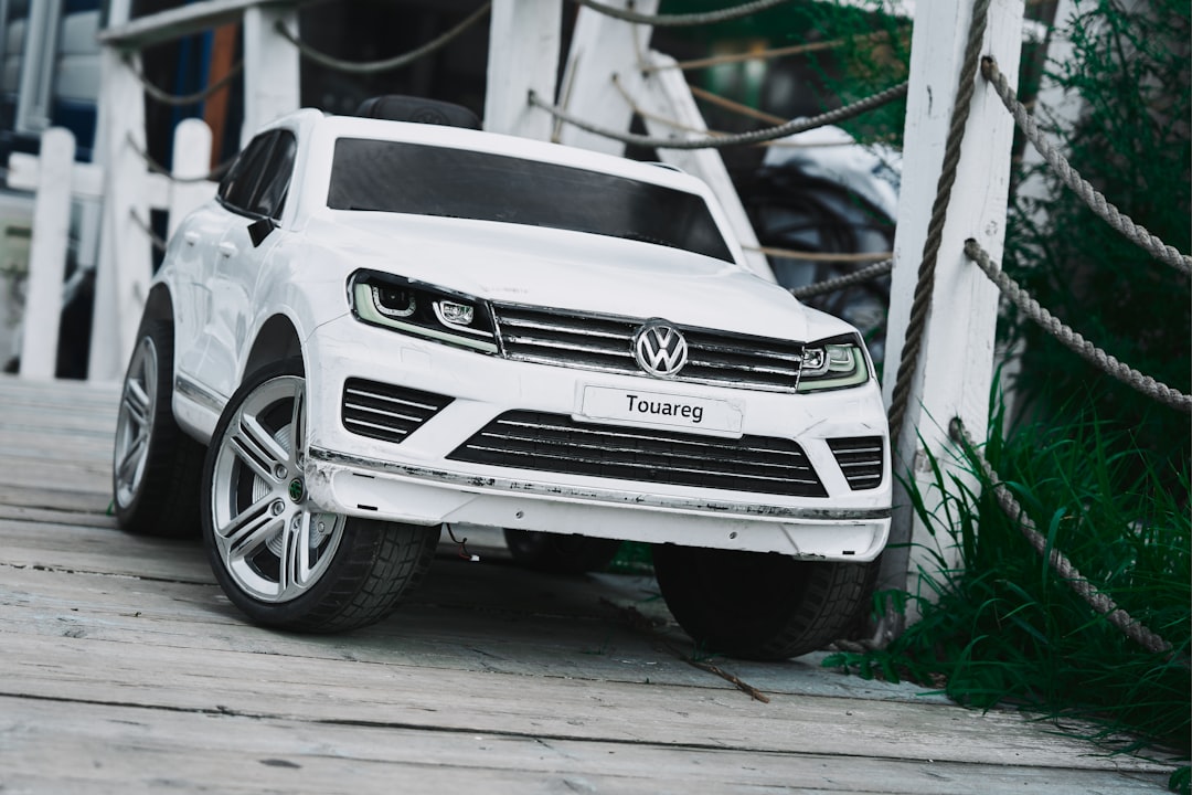 white mercedes benz suv parked beside white wall