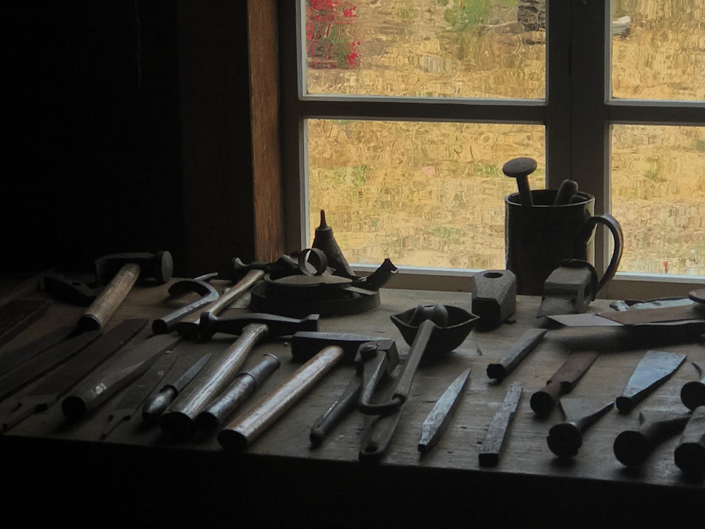 black and gray metal tools on brown wooden table