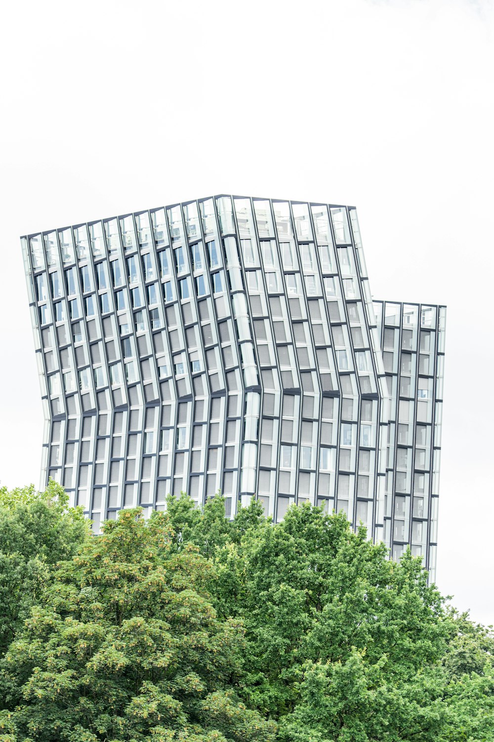 white and black building near green trees during daytime